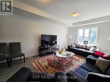 St. Catharines (E. Chester) townhouse for rent - A living room with a rug and a coffee table.