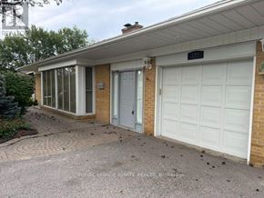 Toronto (Rouge) apartment for rent - A house with a white garage door is for sale.