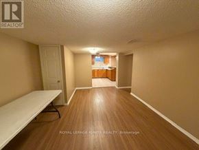 Toronto (Rouge) apartment for rent - A room with wooden flooring and a white bench.