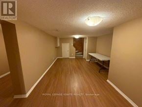 Toronto (Rouge) apartment for rent - A room with wooden floors and a white ceiling with a light fixture.