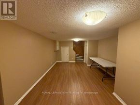 Toronto (Rouge) apartment for rent - A room with wooden floors and a white ceiling light.