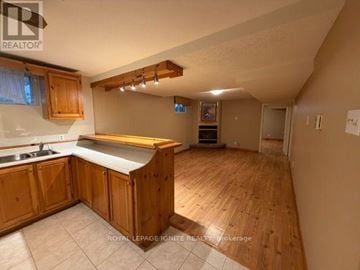 Toronto (Rouge) apartment for rent - A kitchen with wooden cabinets and a countertop.