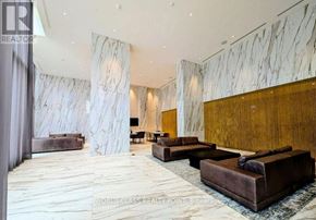 Mississauga (City Centre) condo for rent - A living room with a white marble wall and a brown couch.
