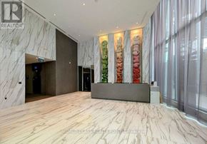 Mississauga (City Centre) condo for rent - A reception area with a wooden floor and a reception desk with a grey top.