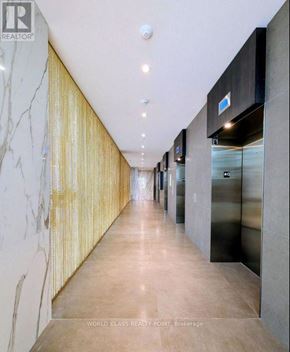 Mississauga (City Centre) condo for rent - A long hallway with marble walls and a gold patterned wallpaper.