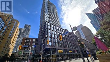 Toronto (Waterfront Communities) condo for rent - A modern kitchen with wooden cabinets and stainless steel appliances.