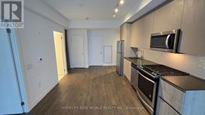 Toronto (Waterfront Communities) condo for rent - A kitchen with a stove top oven and a microwave above it.