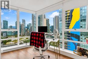 Vancouver apartment for rent - A room with a window overlooking a cityscape.