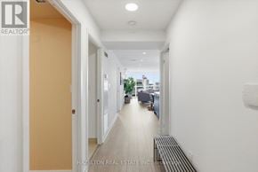 Toronto (Waterfront Communities) condo for rent - A long hallway with a bench at the end.