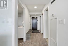 Toronto (Waterfront Communities) condo for rent - A hallway with a bench and a door at the end.