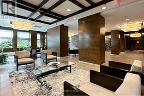 Mississauga (Port Credit) condo for rent - A modern living room with a glass table and a mix of dark and light furniture.