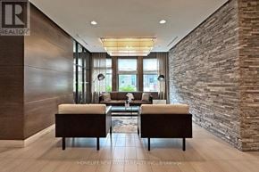 Mississauga (Port Credit) condo for rent - A living room with a stone wall and two couches.