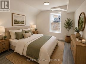 Ottawa triplex for rent - A bedroom with a large bed, a window, and a painting on the wall.