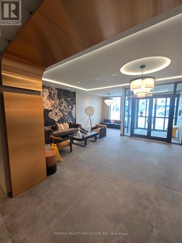 Toronto (Yorkdale-Glen Park) condo for rent - A modern living room with a large sofa and a chandelier.