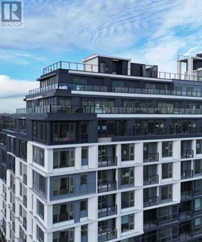 Toronto (Yorkdale-Glen Park) condo for rent - A tall building with multiple balconies and a flat roof.