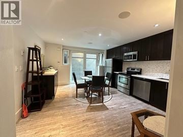 West Vancouver apartment for rent - A kitchen with a dining table and chairs in the middle of the room.