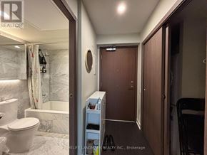 Toronto (Waterfront Communities) condo for rent - A bathroom with a toilet, a shower, and a small closet.
