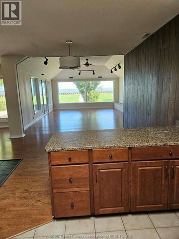 Tecumseh apartment for rent - A kitchen with wooden cabinets and a granite countertop.