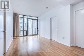 Toronto (Bay Street Corridor) condo for rent - A spacious room with a sliding glass door leading to a balcony.