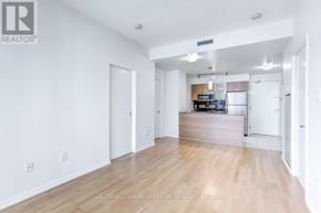 Toronto (Bay Street Corridor) condo for rent - A spacious living room with hardwood floors and white walls.