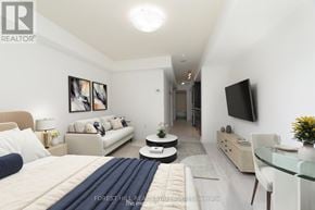 Toronto (Niagara) condo for rent - A well-lit bedroom with a bed, couch, and television.