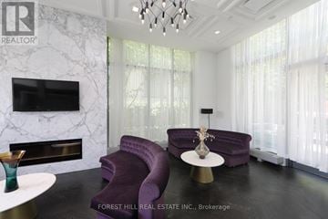 Toronto (Niagara) condo for rent - A living room with a purple couch and a fireplace.