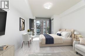 Toronto (Niagara) condo for rent - A bedroom with a large bed and a balcony.