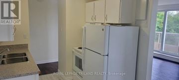 St. Thomas multi-family for rent - A white refrigerator in a kitchen with a sink and a window.
