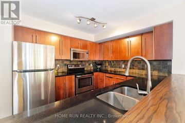 Ottawa townhouse for rent - A kitchen with wooden cabinets and a stainless steel refrigerator.