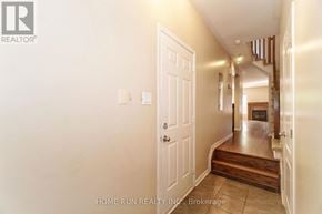 Ottawa townhouse for rent - A hallway with a white door and a logo on the wall.