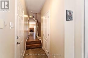 Ottawa townhouse for rent - A hallway with a wooden floor and white walls.