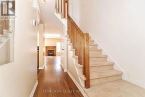 Ottawa townhouse for rent - A staircase with wooden steps and a beige carpeted landing.