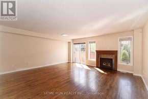 Ottawa townhouse for rent - A spacious room with a fireplace and wood flooring.