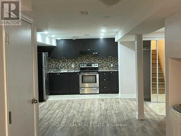 Ajax (Northwest Ajax) apartment for rent - A kitchen with black cabinets and a patterned backsplash is visible from a hallway.
