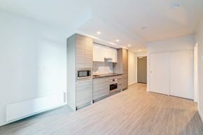 Surrey apartment for rent - A modern kitchen with wooden floors and white walls.