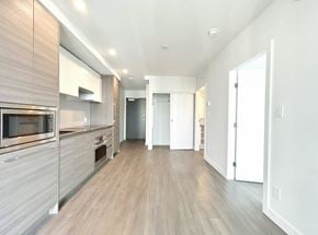 Surrey apartment for rent - A modern kitchen with wooden floors and stainless steel appliances.