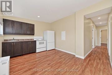 Smiths Falls apartment for rent - A kitchen with brown cabinets and a white refrigerator.