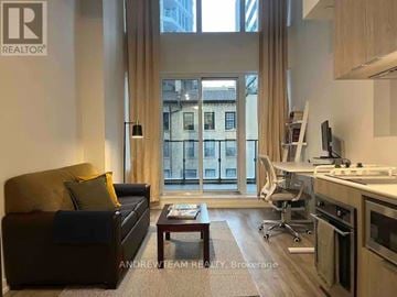 Toronto (Church-Yonge Corridor) condo for rent - A living room with a brown couch and a coffee table in front of a large window.