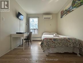 Toronto (Moss Park) apartment for rent - A bedroom with a bed, desk, chair, and window.