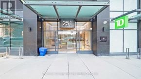 Toronto (Church-Yonge Corridor) condo for rent - The entrance to a building with a glass door and a sign that reads "251".