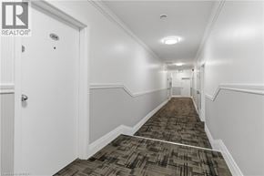 Brantford apartment for rent - A hallway with a carpeted floor and white walls.