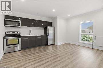 Brantford apartment for rent - A modern kitchen with a stainless steel oven and microwave above the stove.