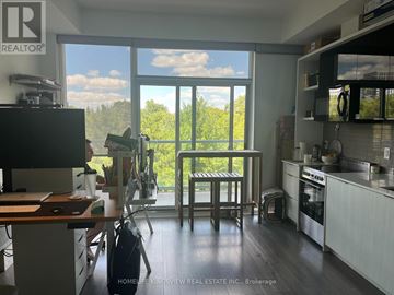Toronto (Casa Loma) condo for rent - A kitchen with a table and chairs in front of a large window.