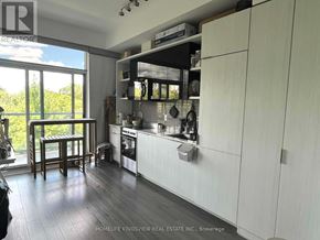 Toronto (Casa Loma) condo for rent - A kitchen with white cabinets and a wooden floor.