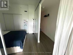 Toronto (Casa Loma) condo for rent - A bedroom with a bed, a dresser, and a mirror.