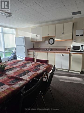 London South (South J) condo for rent - A kitchen with a table and chairs in front of it.