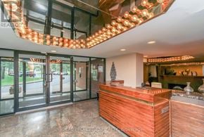 Ottawa condo for rent - A reception area with a wooden counter and a glass door.
