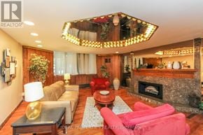 Ottawa condo for rent - A living room with a fireplace and a chandelier.