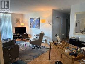 Toronto (Parkwoods-Donalda) condo for rent - A living room with a television, a chair, and a table.