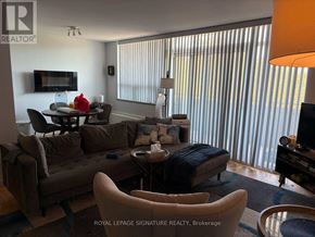 Toronto (Parkwoods-Donalda) condo for rent - A living room with a brown couch and a television.